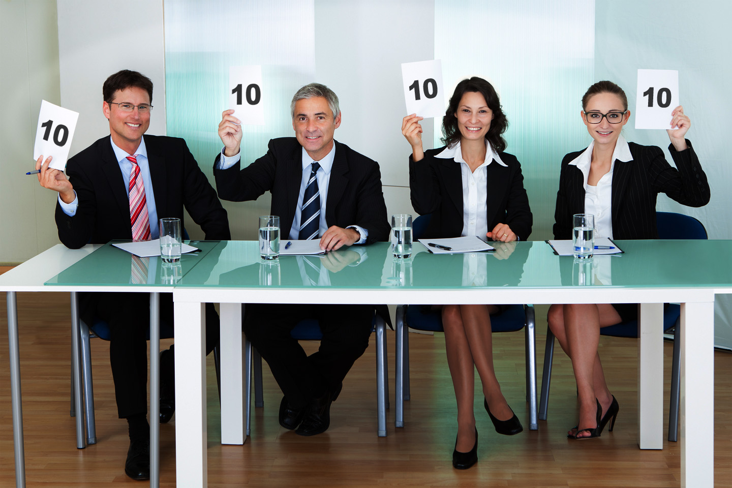 Group of judges holding up blank cards | The Freelancer, by Contently